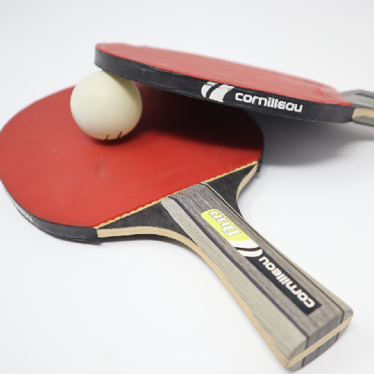 Table tennis paddles and ball on white background
